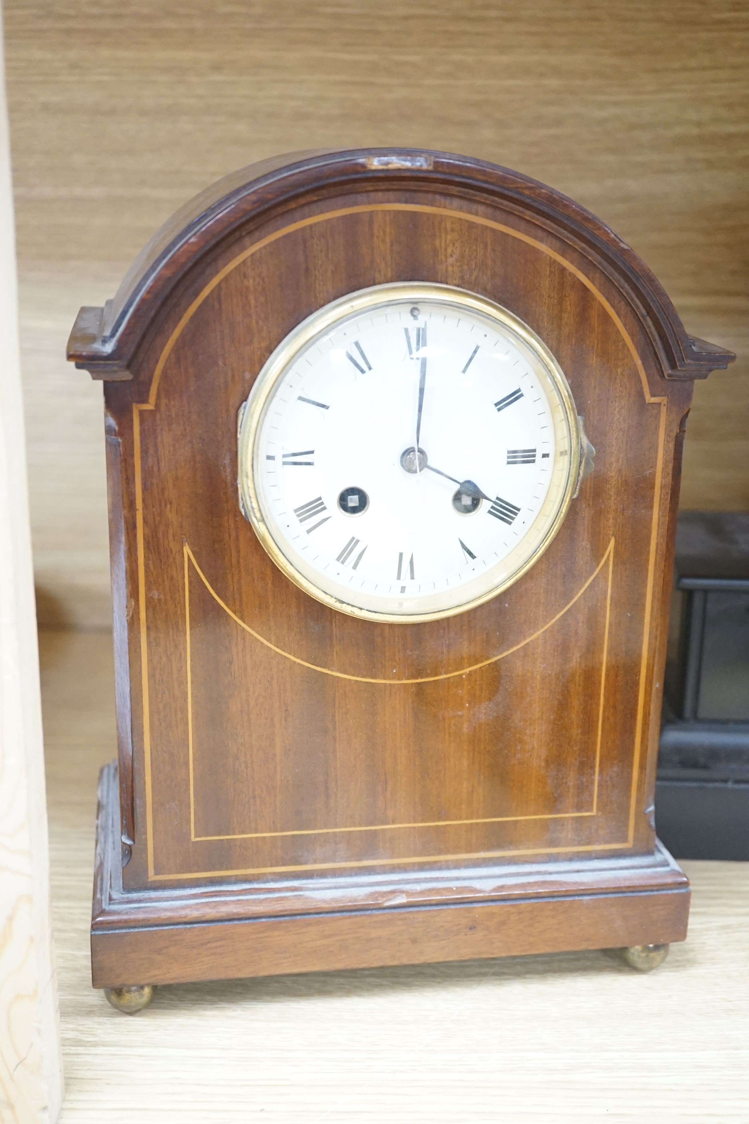 An inlaid mahogany mantel clock, slate mantel clock and a figural spelter mantel clock (3)